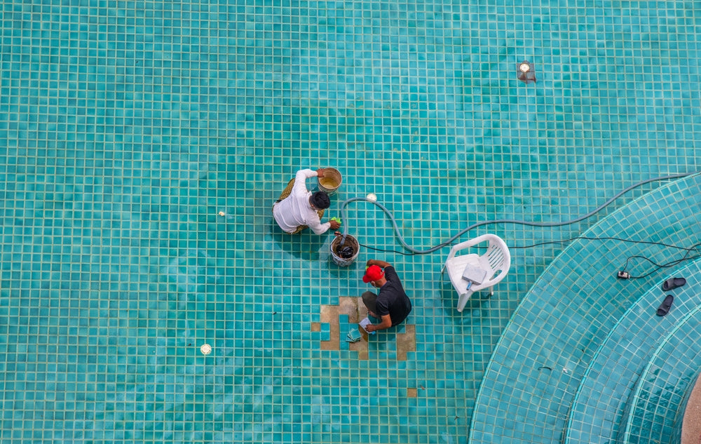 Two People Installing Glass Pool Tile Mosaic