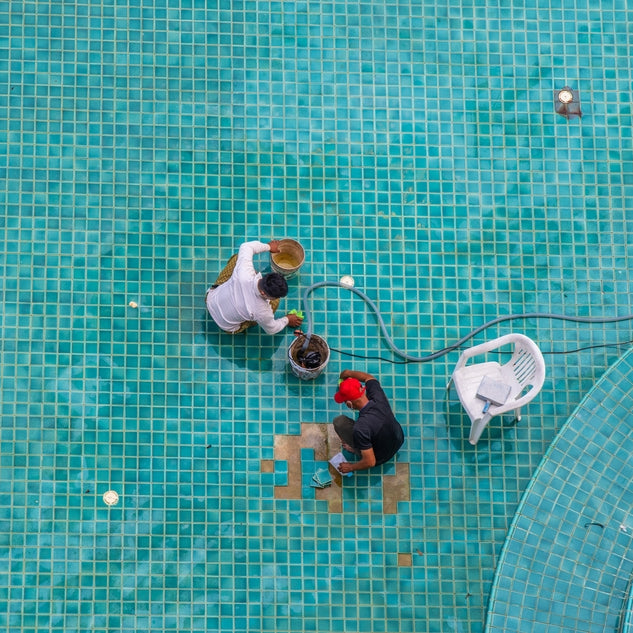 Two People Installing Glass Pool Tile Mosaic