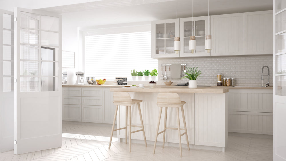 Kitchen with white cabinets and white backsplash tile