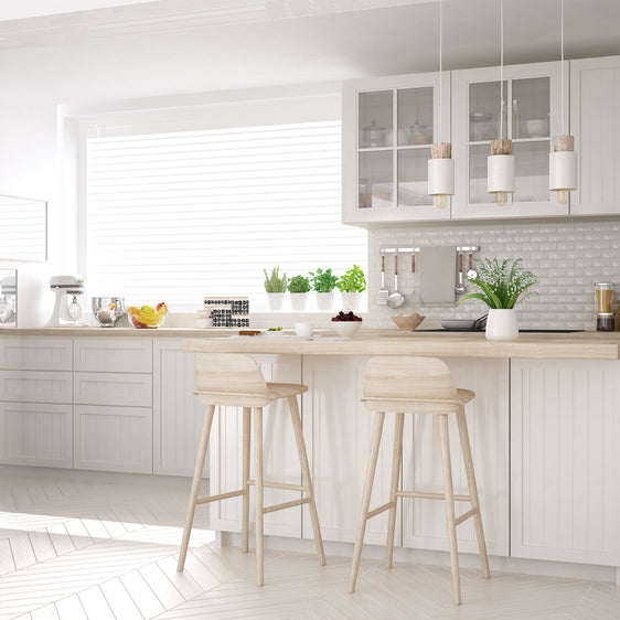 Kitchen with white cabinets and white backsplash tile
