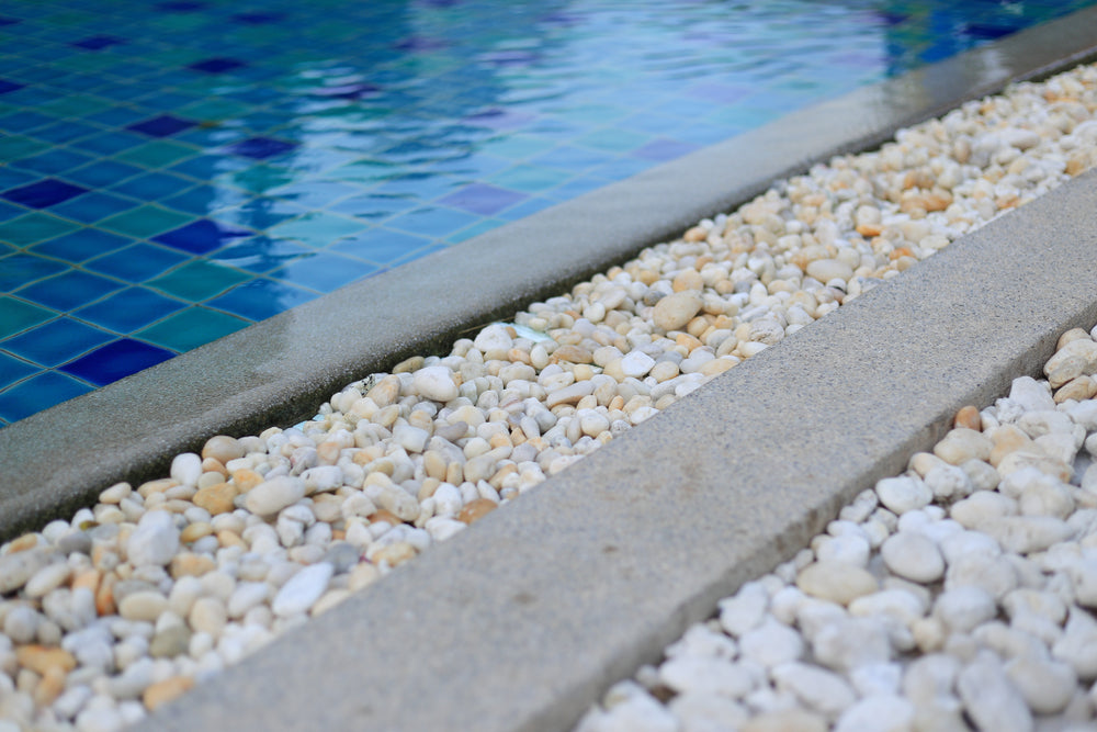  Close up of pool and waterline tiles and pebbles